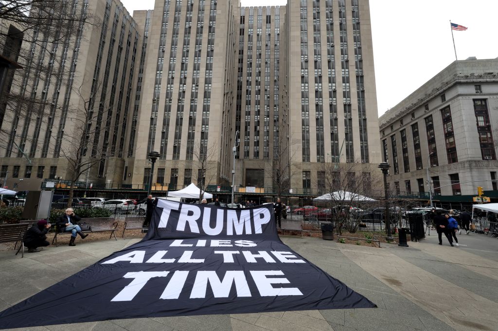 Demonstrators unfurl a banner near Manhattan Criminal Court