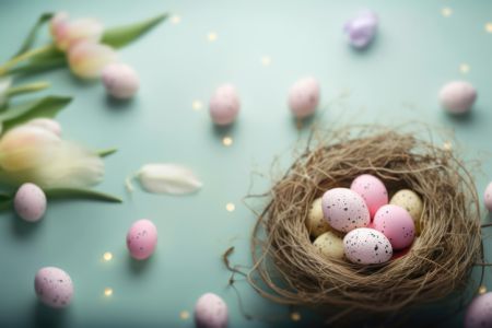 Colorful Easter Eggs on Blue Background with Tulips and Spring Flowers