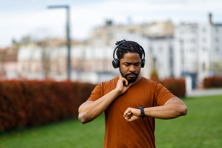 An African Man is Checking his Heart Rate After a Training.