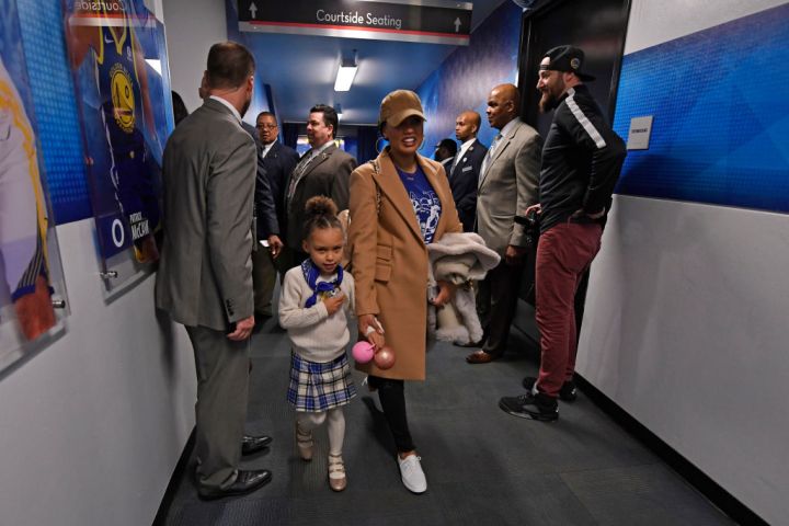 Riley Curry walks with her mother Ayesha Curry before the start of the Golden State Warriors vs. Memphis Grizzlies NBA game at the Oracle Arena in Oakland, Calif., on Saturday, Dec. 30, 2017. Curry returns to the floor tonight after sustaining an ankle in