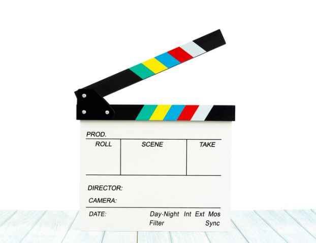 The Film slate or Flying clapperboard on wooden table isolated on white background, Save clipping path.