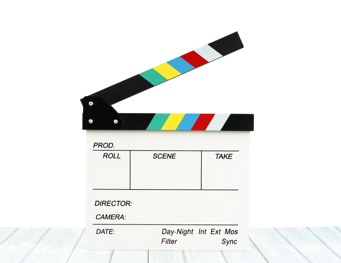The Film slate or Flying clapperboard on wooden table isolated on white background, Save clipping path.