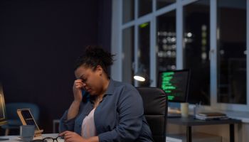 Exhausted woman working till late night in office
