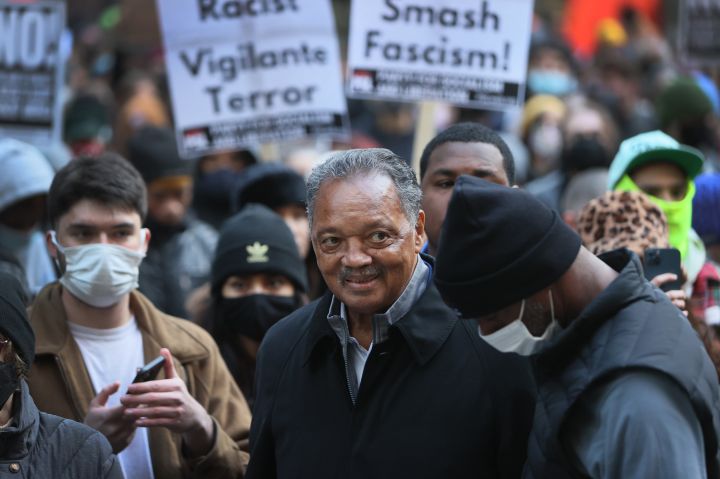 Civil rights leader Rev. Jesse Jackson marches with activists protesting the verdict in the Kyle Rittenhouse