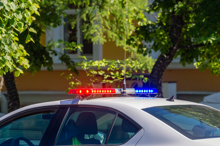 The flashing light on the police car is on