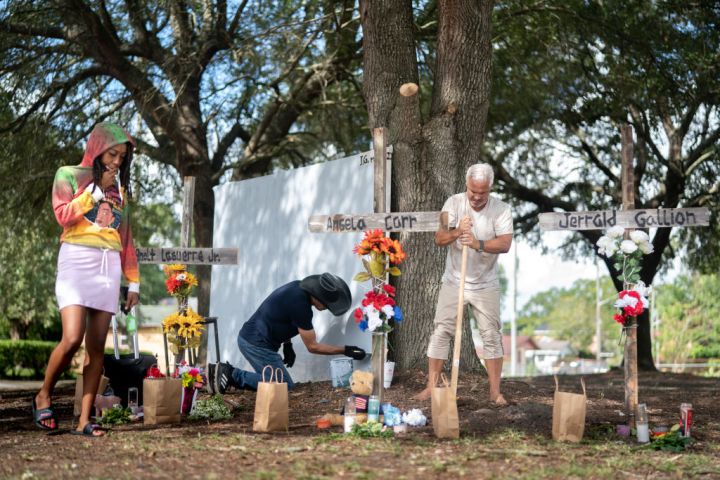 Texas based artist Robert Marquez, left, and Floridian Will Walsh work on memorials