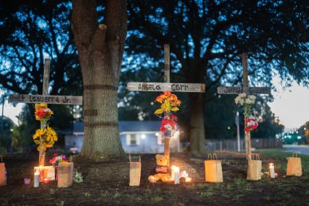 Candles burn at memorials for Angela Carr, Anolt Joseph Laguerre Jr. and Jerrald Gallion.