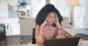 Frustrated business woman, laptop and headache in stress, mistake or burnout at office. Tired female person or employee in anxiety, mental health or fatigue from debt or financial crisis at workplace