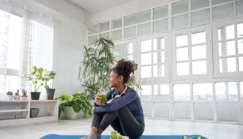 Young women practice yoga at home