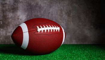 An American Football ball over grass