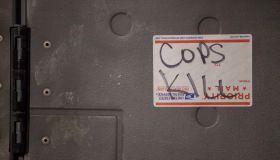 "Cops Kill" is scrawled on a United States Postal Service...