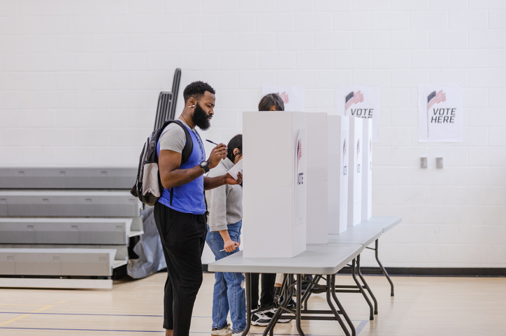 Young male college student thinks about his choices while voting