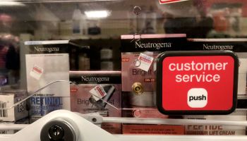 Anti-theft locked merchandise on shelves with customer service button at CVS pharmacy, Queens, New York