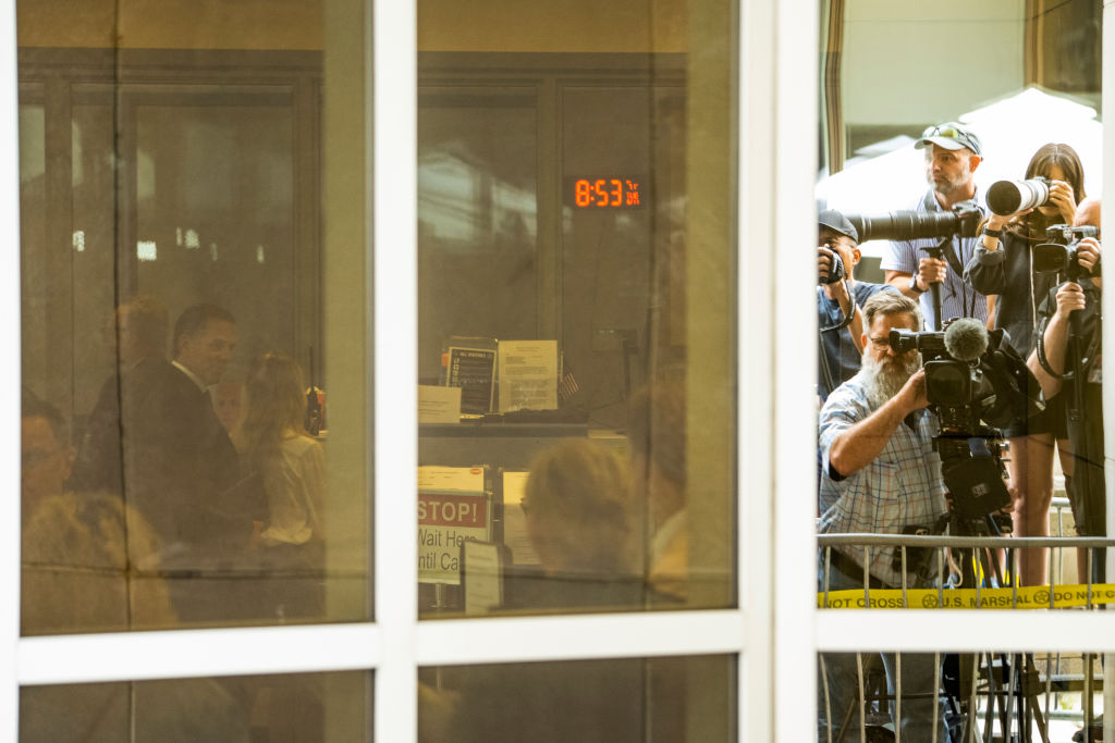 Hunter Biden, seen through a window, arrives at federal court i