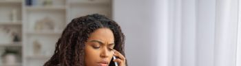 Young Black Woman Consulting With Doctor Over Phone Regarding Medication