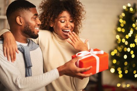 African-american couple celebrating Christmas at home, free space