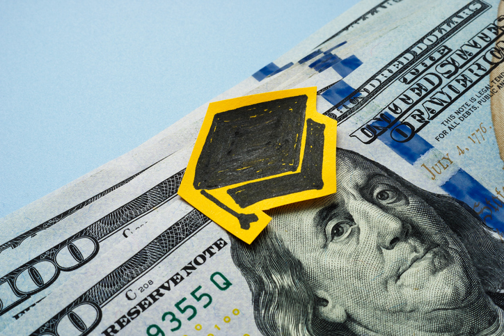 Graduation cap and dollars. Scholarship or student loan.