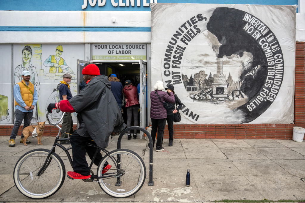 People who lost their homes in recent wildfires, environmental groups, and union members rally at the Pasadena Community Job Center