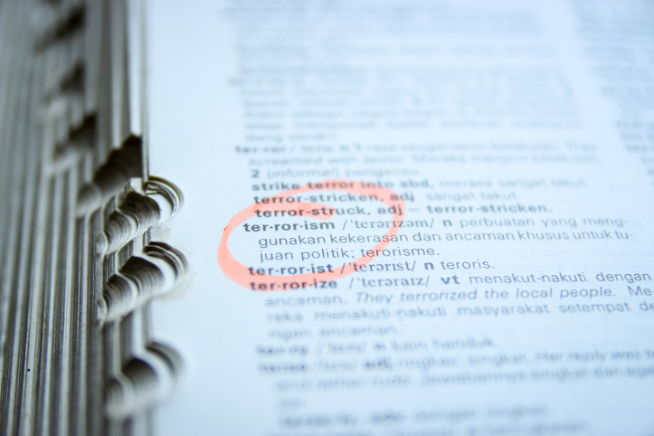 An Open Dictionary with Highlighted Word "Terrorism"
