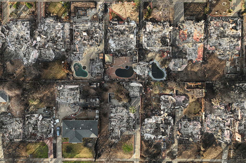 Eaton fire damaged homes and businesses in the rain.