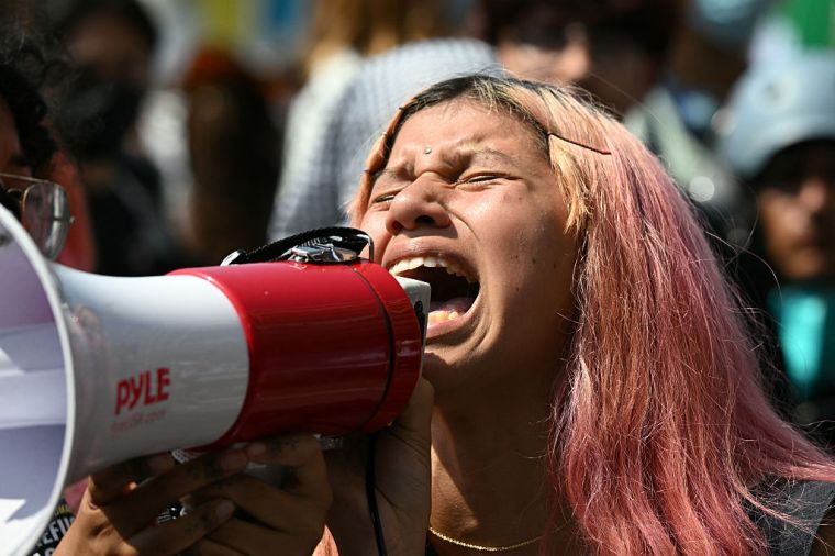 A protester shouts into a megaphone outside the Federal Building