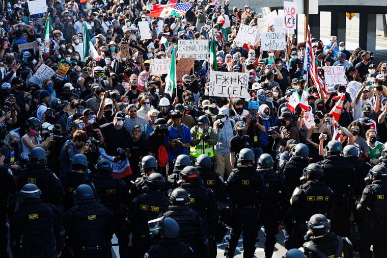 California Highway Patrol officers forcing protestors back onto an on-ramp to the 101 freeway