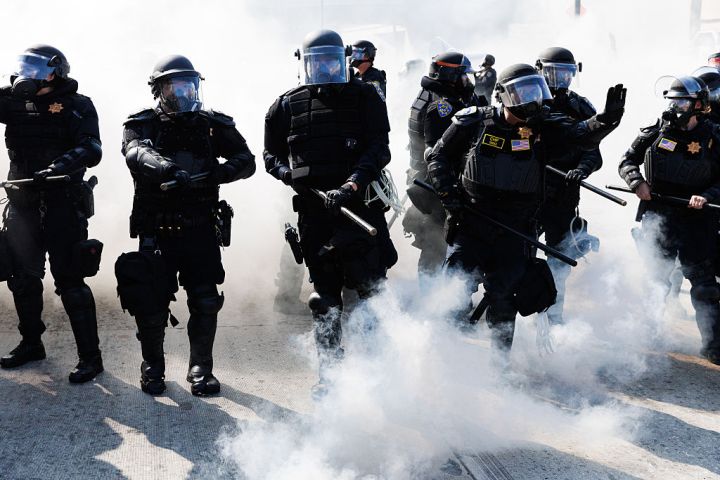 California Highway Patrol using smoke grenades to advance and push protestors off the 101 freeway