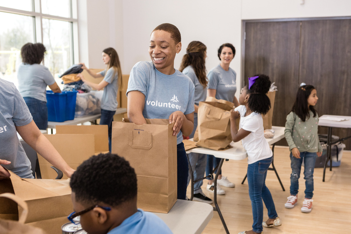 Volunteers Packing Bags at Charity Event, Teamwork and Community