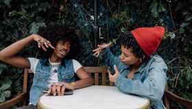 Couple of friends sitting on a sidewalk cafe enjoying a break