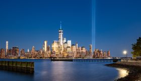 Skyline of Lower Manhattan with Tribute in Light commemoration in evening. World Trade Center skyscrapers and Hudson River, New York City, USA