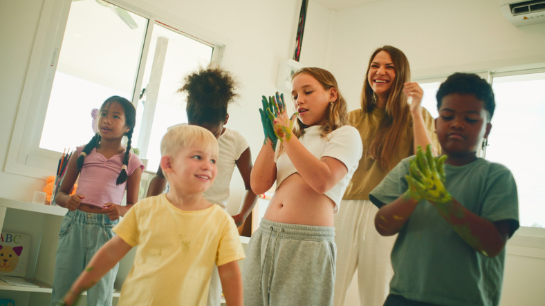 Group of children with colored hands.