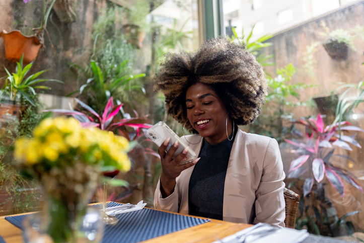 Transgender businesswoman using the mobile phone at a restaurant