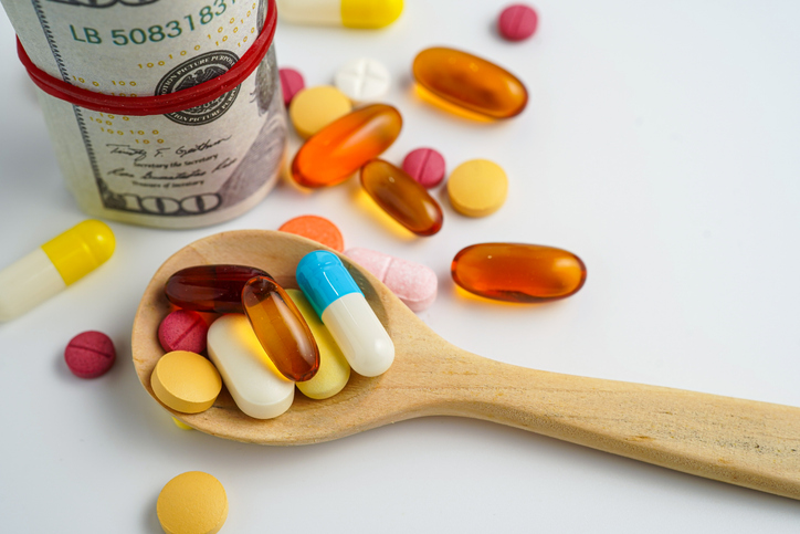 Medicine prescription drugs cost concept, Pills on money dollars, healthcare expenses