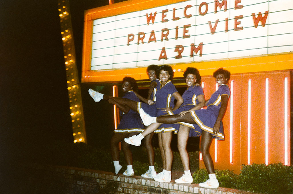 Prairie View A&M cheerleaders posing in front of sign