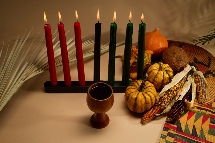 Kwanzaa Celebration Setup. A Kwanzaa display with candles, fruit, and a cup symbolizing unity.