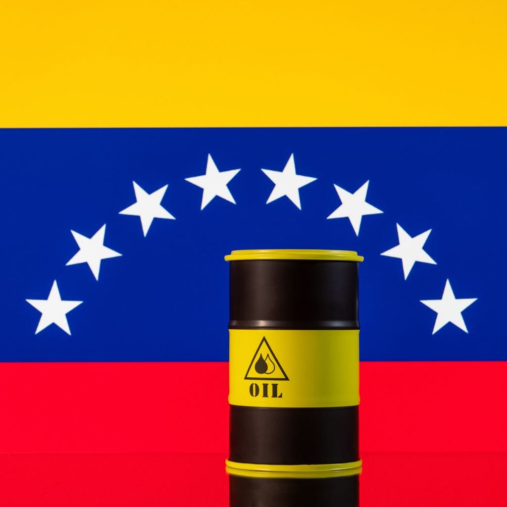 An iron barrel for oil products against the backdrop of the Venezuelan flag.