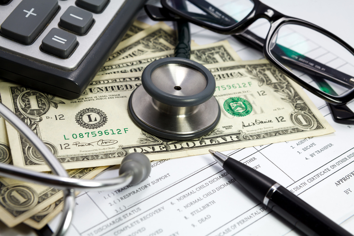 Health care costs. Stethoscope and money symbol for health care costs or medical insurance
