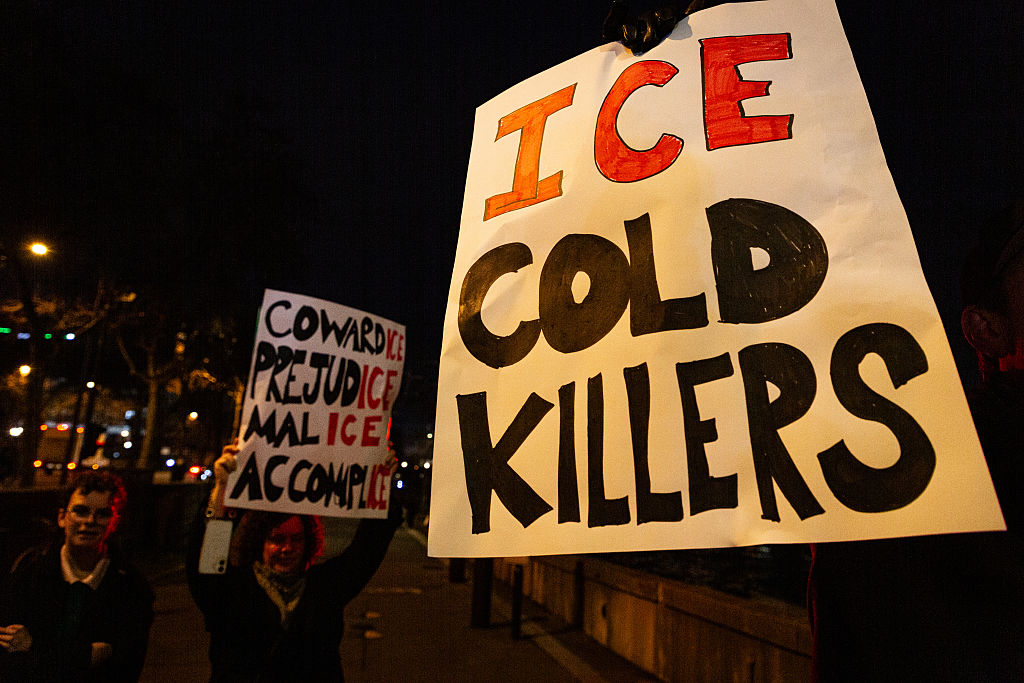 A placard that says "ICE cold killers" seen in the middle of...