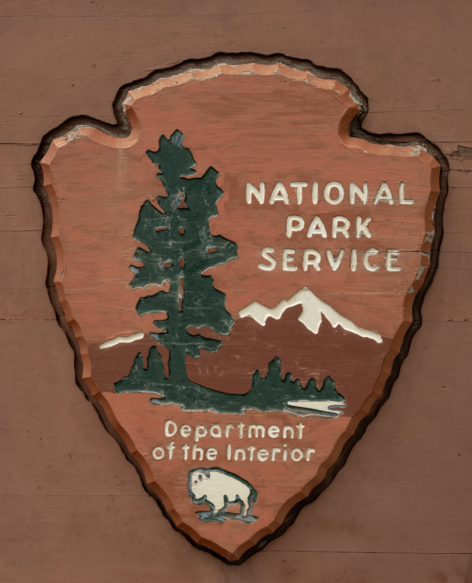 Worn National Park Logo Carved In Wood