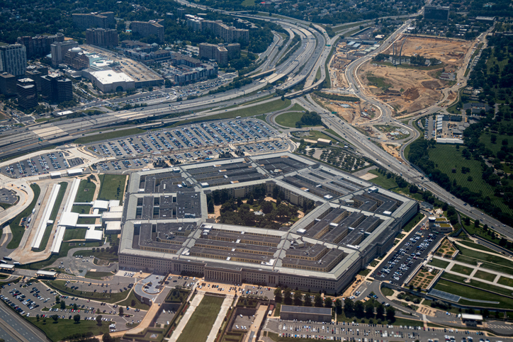 Aerial view of the Pentagon complex with surrounding roads, parking and greenery. g