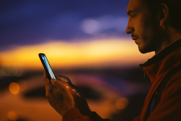 Man Using Smartphone at Sunset, Twilight Portrait of Mobile Ai Technology and Evening Communication