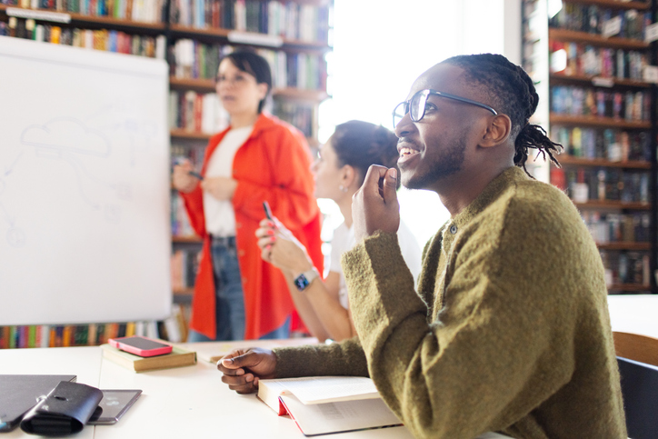 Diversity group of colleagues engaged in a business discussion in a modern library room