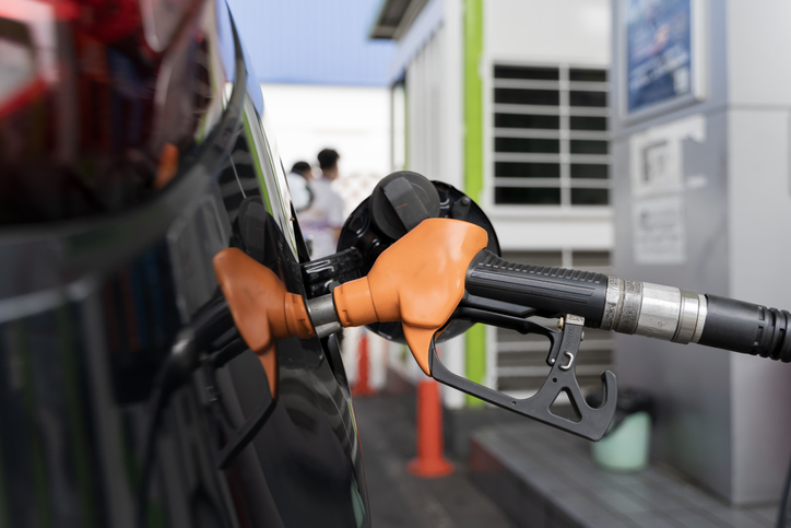 Orange Fuel Nozzle Refueling Car at Gas Station