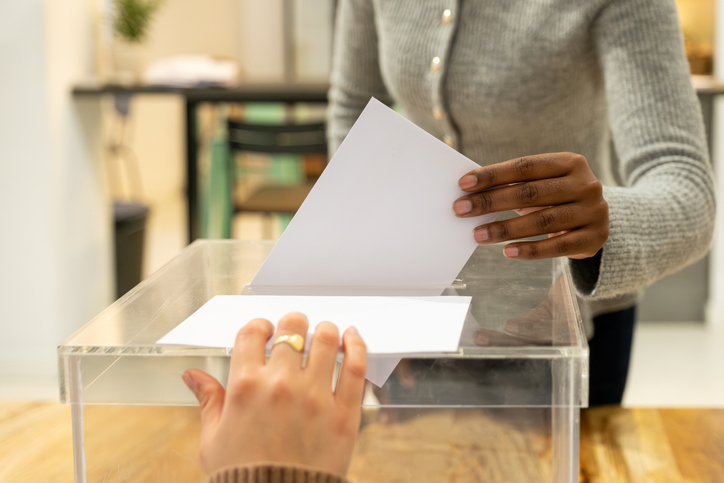 People voting in transparent ballot box on polling day