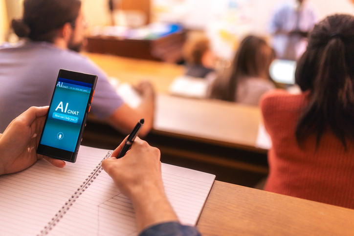 student using AI app on mobile phone during universitylecture in amphitheater
