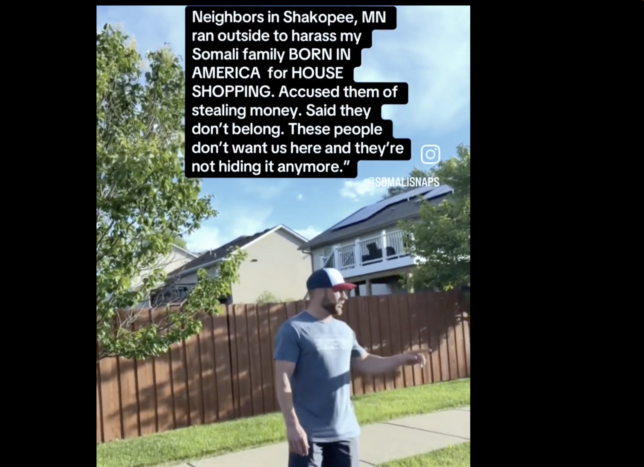 A person standing in a residential yard, with text overlay stating that neighbors in Shakopee, Minnesota harassed the person's Somali family for house shopping, accusing them of stealing money and saying they don't belong there.