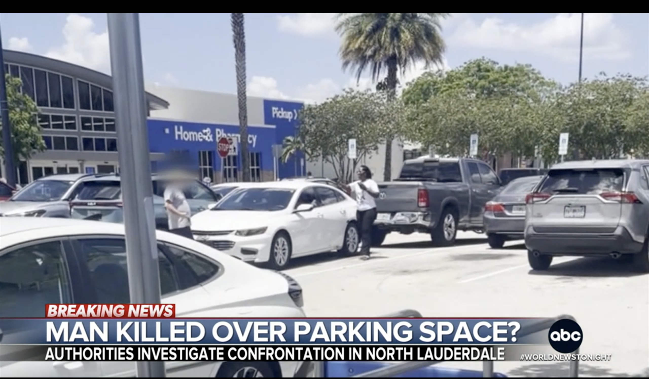 Parking lot with several vehicles, including a white sedan that appears to have been involved in an incident, as indicated by the "Breaking News" overlay.
