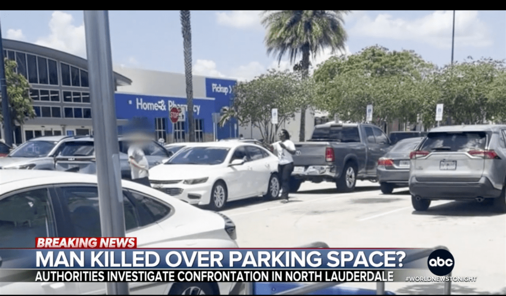Parking lot with several vehicles, including a white sedan that appears to have been involved in an incident, as indicated by the "Breaking News" overlay.