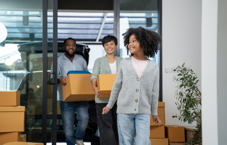 Young couple with daughter moving to their new home