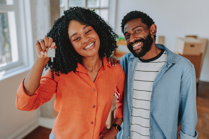 Moving into a new home, a happy couple smiling